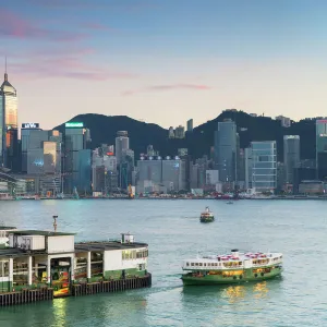 View of Star Ferry Terminal and Hong Kong Island skyline at dusk, Hong Kong, China, Asia