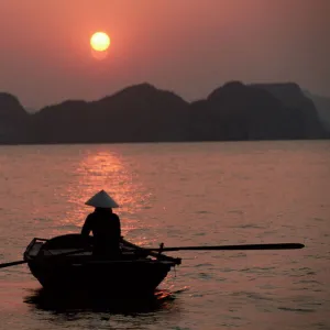 Woman rowing woven skiff