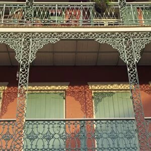 Detail of wrought iron and wooden shutters on balconies