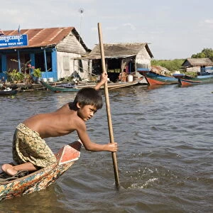 Young boy in a boat on Tonle Sap Lake, Cambodia, Indochina, Southeast Asia, Asia