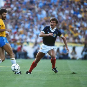 Brazils Socrates takes on Scotland at the 1982 World Cup