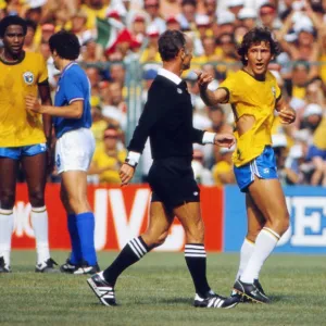 Brazils Zico remonstrates with the referee after his shirt is ripped at the 1982 World Cup