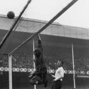 Everton goalkeeper Gordon West tips over a shot as Spurs Jimmy Greaves looks on at Goodison Park