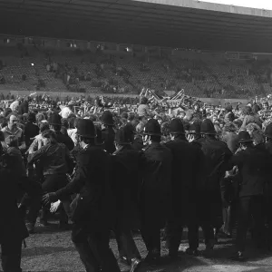 Police try to stop Manchester United fans invading the Old Trafford pitch after Denis Laws goal relegates the club in 1974