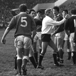 Referee Roger Quittenton steps-in to stop the Scottish and Welsh forwards fighting - 1983 Five Nations