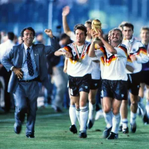 Rudi Voller celebrates with the World Cup trophy in 1990