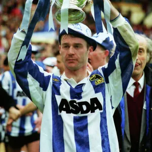 Sheffield Wednesday goalscorer John Sheridan holds aloft the League Cup trophy in 1991