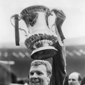 West Ham captain Bobby Moore lifts the FA Cup in 1964