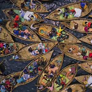 Aerial view of people sitting on traditional boats at Old Dhaka river port along