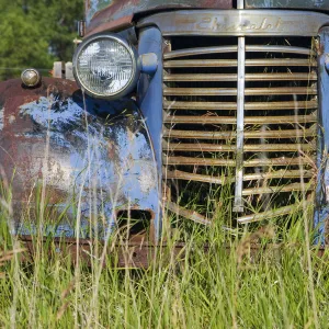 Canada. An old car in a farmers field on the Canadian Prairie