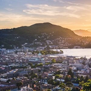 Como, Lombardy, Italy. High angle view over the city and the Como Cathedral at sunset