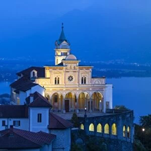 Elevated view over the picturesque Sanctuary of Madonna del Sasso illuminated at dusk