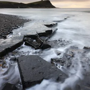 High tide flows around the broken ledges on the shores of Kimmeridge Bay on the Jurassic Coast