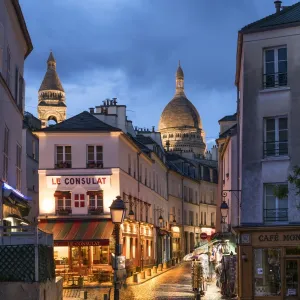 Montmartre at night with illuminated Sacre Coeur Basilica in the background, Paris