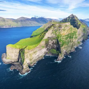 Panoramic aerial view of the island of Kalsoy with the Kallur lighthouse cliff in the foreground, Kalsoy island, Faroe islands, Denmark