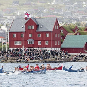 Rowing boats competition in occasion of "lavsoka festival in the city of Torshavn. In the background the red buildings of Tinganes. Island of Streymoy. Faroe Islands