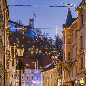 Sritar street with Ljubljana Castle in the background adorned with Christmas lights