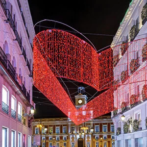 Street adorned with Christmas lights near Puerta del Sol, Madrid, Spain