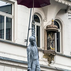 Suspended man with umbrella street sculpture, Prague, Bohemia, Czech Republic