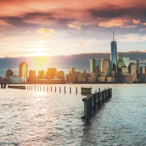 USA, New York City, View of New York city from Jersey city with the sun rising above the Financial district
