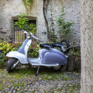 White and grey Lambretta Innocenti scooter in a courtyard, Morbegno, province of Sondrio