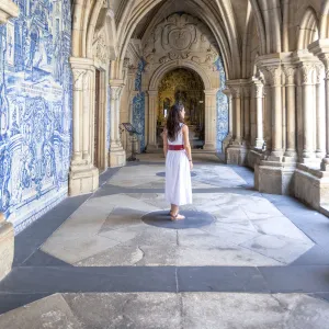 A woman admires the cloister arcades of Porto Cathedral (Sao do Porto), Porto