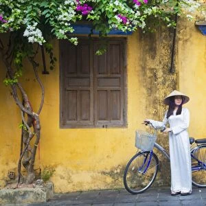 Woman wearing Ao Dai dress with bicycle, Hoi An (UNESCO World Heritage Site), Quang Ham