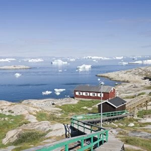 Colourful houses in Illulisat on Greenland. Ilulissat is a UNESCO World Heritage Site because of the Jacobshavn Glacier or Sermeq Kujalleq which is the largest glacier outside Antarctica. The glacier drains 7% of the Greenland ice sheet and