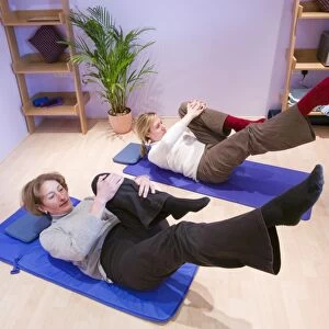 A Pilates instructor and student doing Pilates