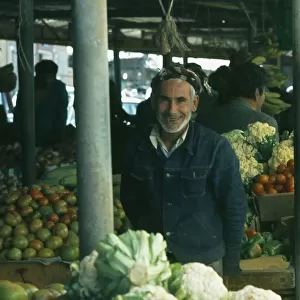 Qatar, Doha, The Souk or market with man selling vegetables at his stall