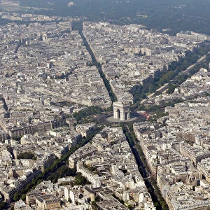 An aerial view shows the Arc de Triomphe and rooftops of residential buildings in