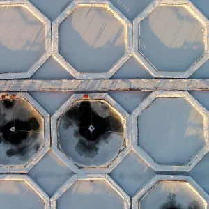 An aerial view shows employees working on fishponds for trout and sturgeon at a fish