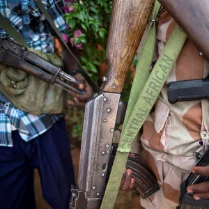 An armed fighter belonging to the 3R armed militia displays his weapon in the town of