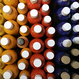 Bottles of coloured inks used for tattooing are displayed for sale at the International