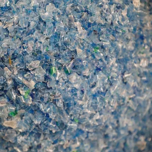 Chips made from recycled plastic bottles are seen before being processed at the Weeco