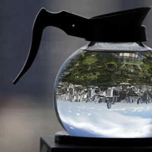 A coffee pot filled with water acts as a lens to depict Lumpini Park in Bangkok