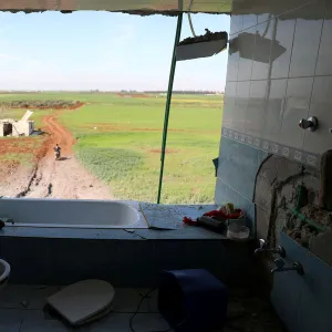 Damaged bathroom in a house, in al-Harak town, near Deraa