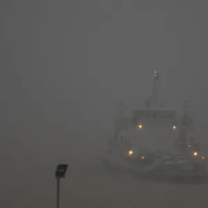 A ferry crosses the Mekong river during a heavy rain, in Phnom Penh