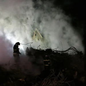 Firefighters work at the site where a building collapsed, in downtown Sao Paulo