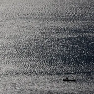 A fisherman checks his net on the Lake Leman near Vevey