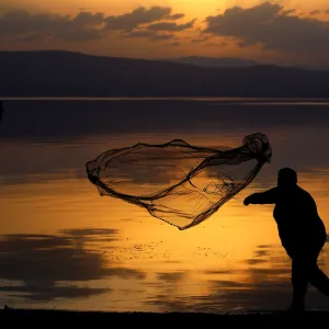 A fisherman uses his net at Lake Ohrid in Ohrid