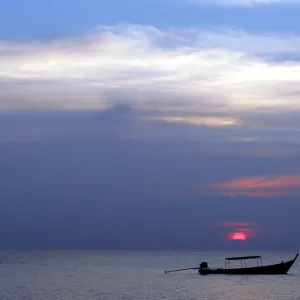 Fishing boat sits anchored in calm waters off coast in Thailands Phang Nga province