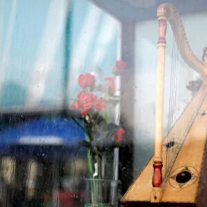 A harp that is held by an image of Saint Cecilia, patron of musicians