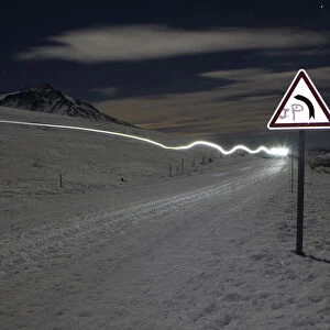 The headlight of a musher is pictured during the tenth stage of La Grande Odyssee sled