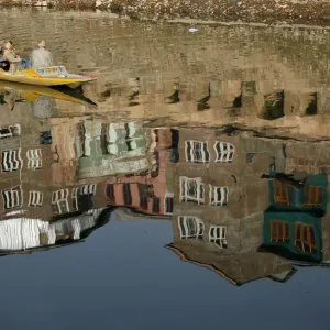 A Kashmiri boatman ferries people across the Jhelum river in Srinagar