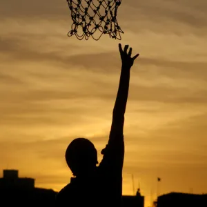 An Indian girl plays basketball in the evening in Chennai