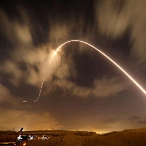 Iron Dome anti-missile system fires an interceptor missile as rockets are launched