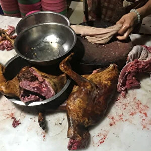 A man cuts dog meat at a dog meat restaurant ahead of local dog meat festival in Yulin