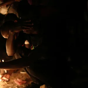 A man prays at one of the stations as he walks the Way of the Cross during Good Friday