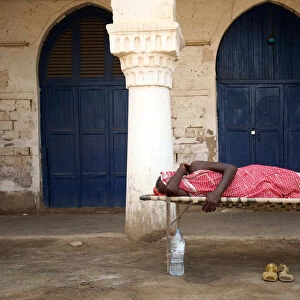 A man sleeps outdoors in the port city of Massawa